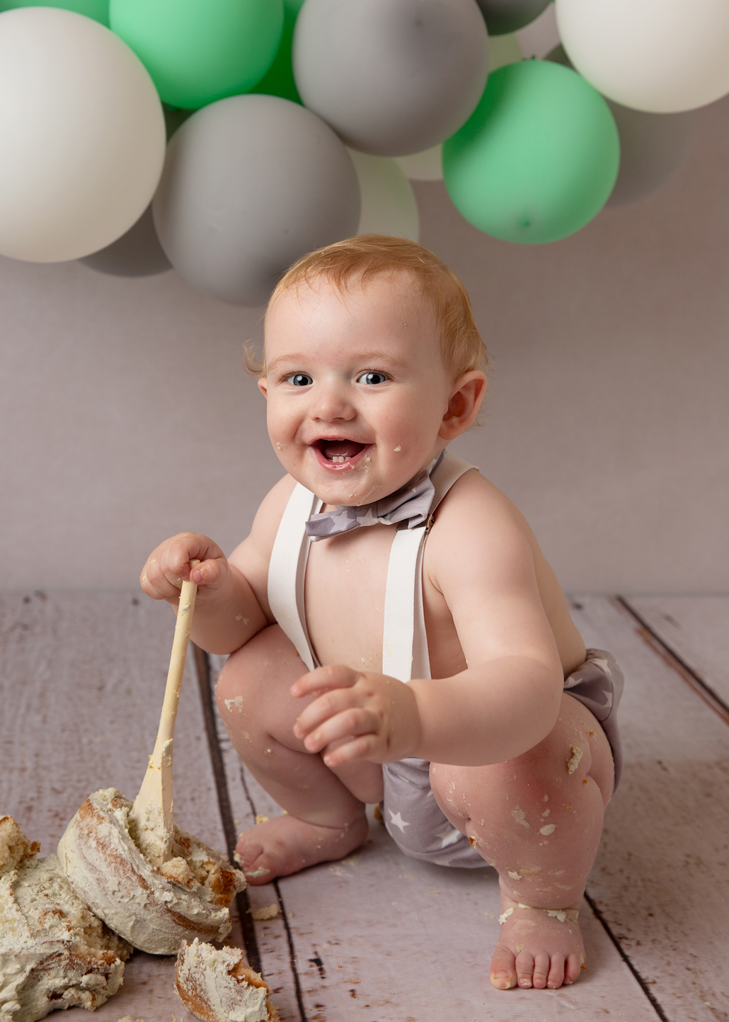 newborn and family photographer ipswich cake smash laughing boy with spoon newborn and family photographer ipswich cake smash laughing boy with spoon