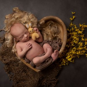newborn and family photographer ipswich tiny baby with yellow flowers