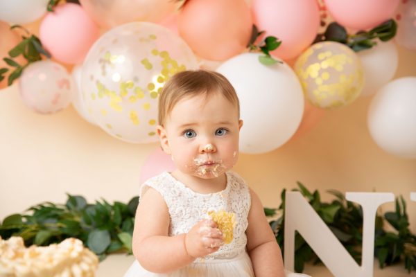 cake smash photographer ipswich peach floral cake eating