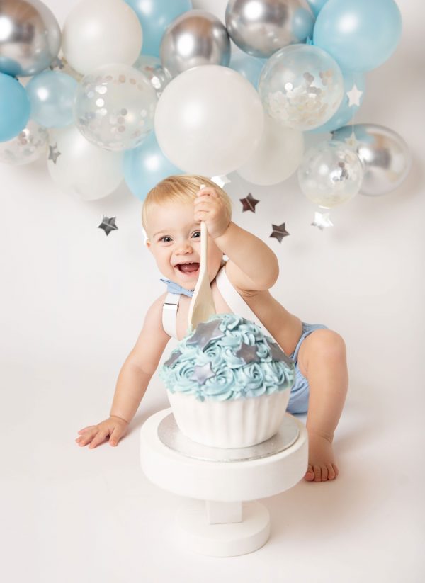 cake smash photographer ipswich boy with silver blue and white setup