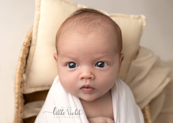 newborn photography ipswich baby eyes wide open with white pillow