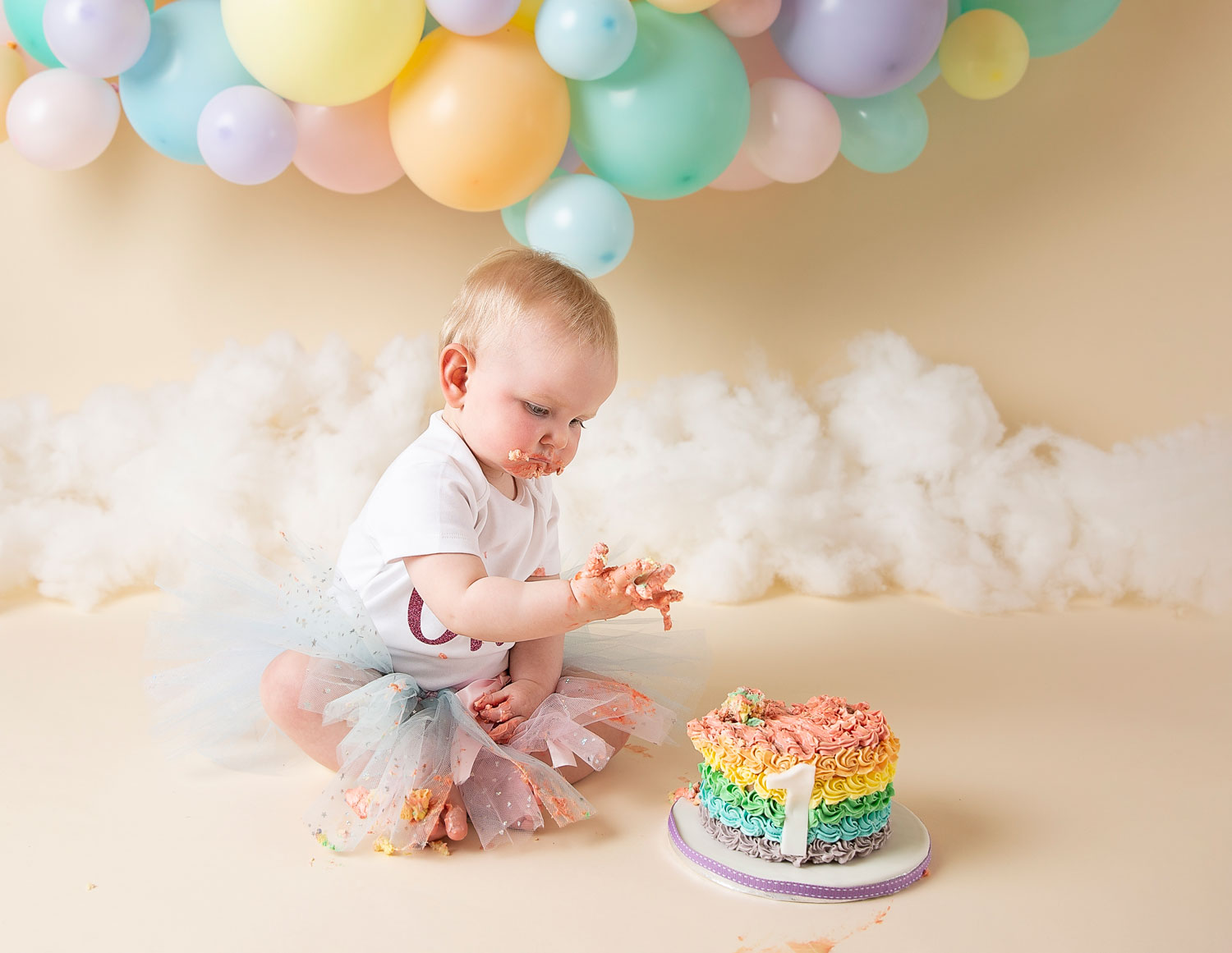 cake smash photographer ipswich pastel rainbow balloon girl 1st birthday 1